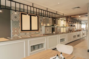 A modern kitchen with a long counter, white cabinetry, and patterned backsplash. - TUI SUNEO PERLA ADULTS ONLY (Sunny Beach)