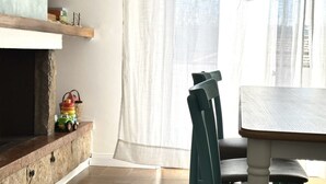 A room with a stone fireplace, a wooden table, and a chair. - SE041 - Senigallia,  four-room apartment super equipped 150m from the sea (Senigallia)