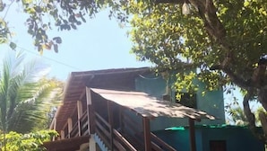 A two-story building with a staircase leading to the upper floor. - Pousada Tulum (Maraú)