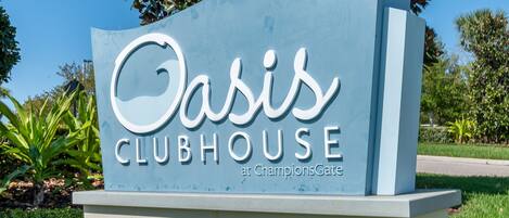 A sign for Oasis Clubhouse at ChampionsGate.