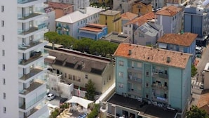A coastal cityscape with a mix of modern and traditional buildings, a beach in the background, and a clear view of the sea. - Apartment 'Residence Bafjle 42' with Shared Pool, Private Terrace and Air Conditioning (Jesolo)