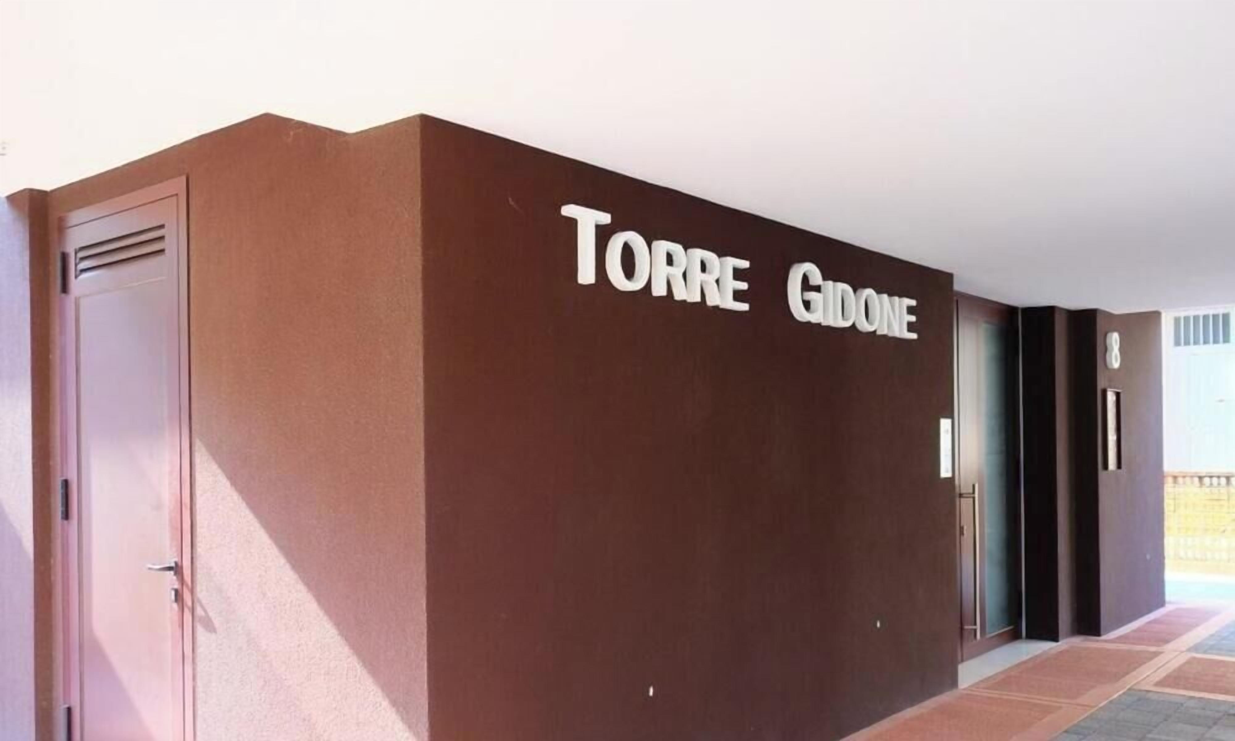 A building facade with the name 'TORRE GIDONE' in large letters.