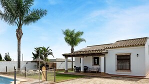 A house with a patio, a swimming pool, and a covered outdoor seating area. - Holiday Home 'Casa Ale' with Private Pool, Private Terrace and Wi-Fi (Cádiz)