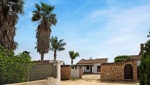 A gated entrance with a dirt path leading to a building with a tiled roof and stone walls. - Holiday Home 'Casa Ale' with Private Pool, Private Terrace and Wi-Fi (Cádiz)