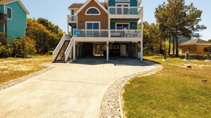 A two-story house with a balcony and a covered entryway.