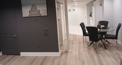 furnished basement studio, with1 queen bed, a kitchenette, and 1 bathroom.