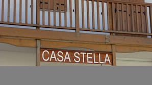 A wooden balcony railing with a sign that reads "CASA STELLA". - Casa Stella 8 (Falcade)