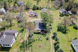 Houses stand amidst well-manicured lawns and trees in a peaceful neighborhood.