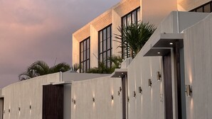 A modern building with large windows and a flat roof. - Vesna Townhouse 1 (Canggu)