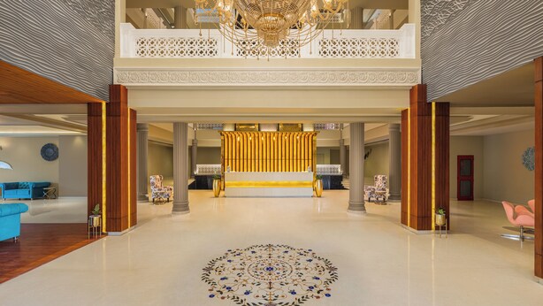 A spacious lobby with a grand chandelier, a central seating area, and a decorative floor pattern. - Essentia Udaipur Luxury Resort & Spa (Udaipur)