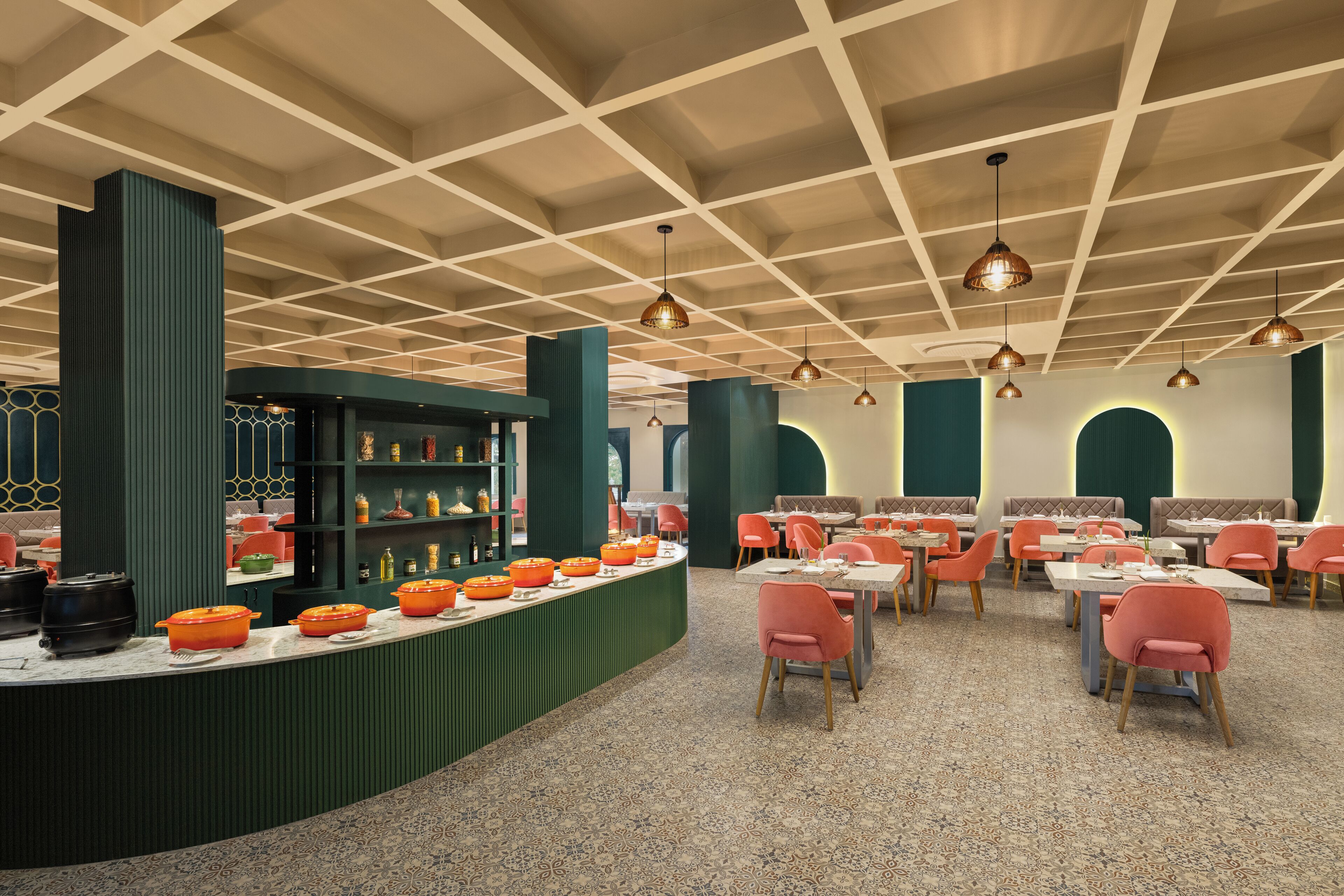 Un restaurante con mostrador central, varias áreas de estar e iluminación colgante.