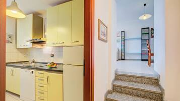 Family Apartment, 3 Bedrooms, Mountainside (Ortensia Blu Lake And Relax) | Private kitchen | Fridge, microwave, stovetop, dishwasher