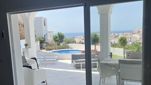 A modern interior with a sliding glass door leading to an outdoor patio area. - AP393 LOS ALMENDROS (Nerja)