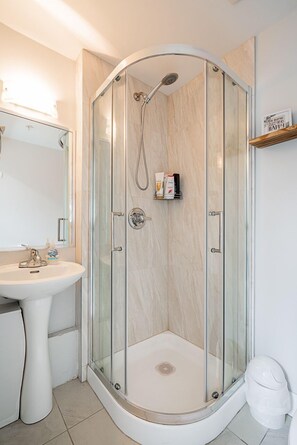 Shower, hair dryer, towels, soap