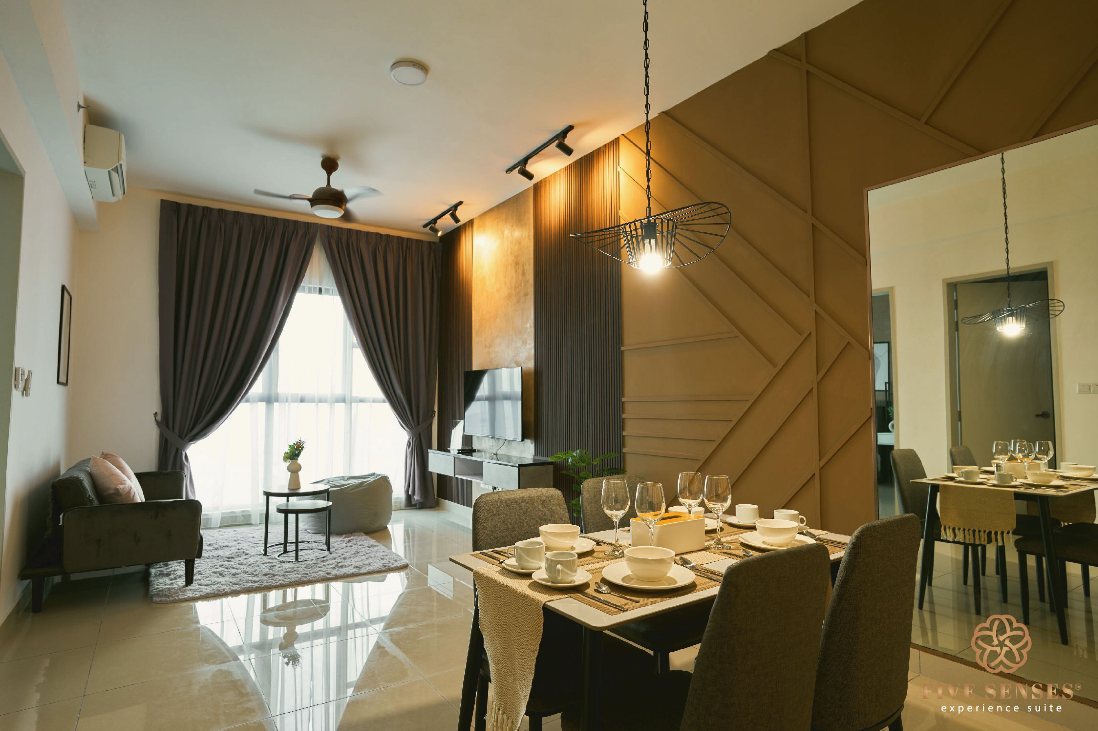 A modern dining area with a table set for four, a ceiling fan, and a large window with curtains.