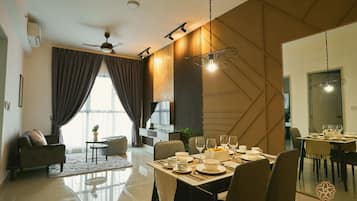A modern dining area with a table set for four, a ceiling fan, and a large window with curtains.