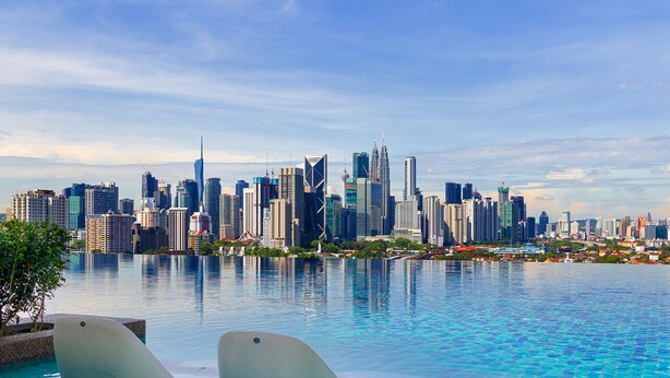 A city skyline with modern skyscrapers and a pool area in the foreground. - Datum Jelatek Sky Residence Roam (Ampang)