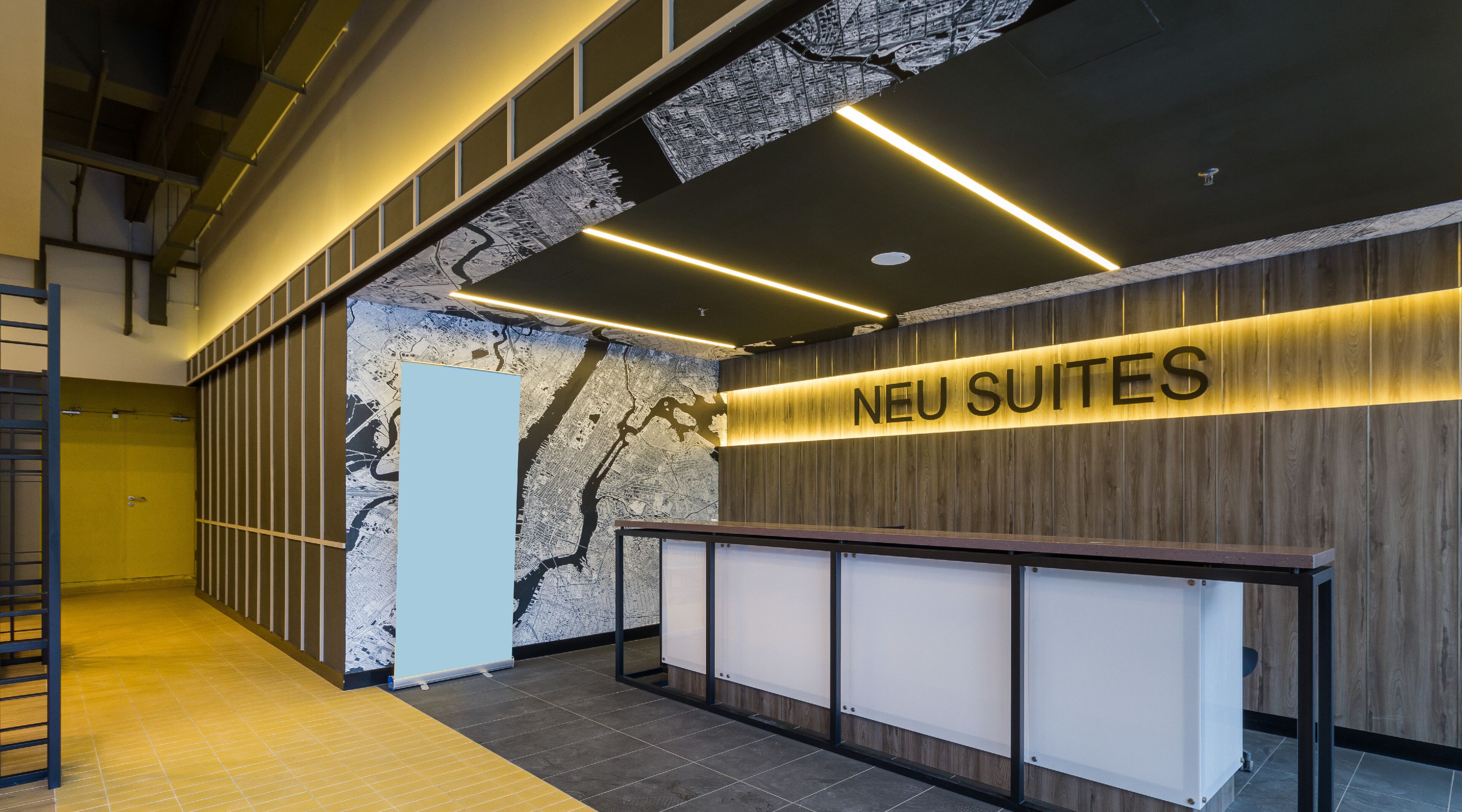 A reception area with a wooden wall and a map mural.