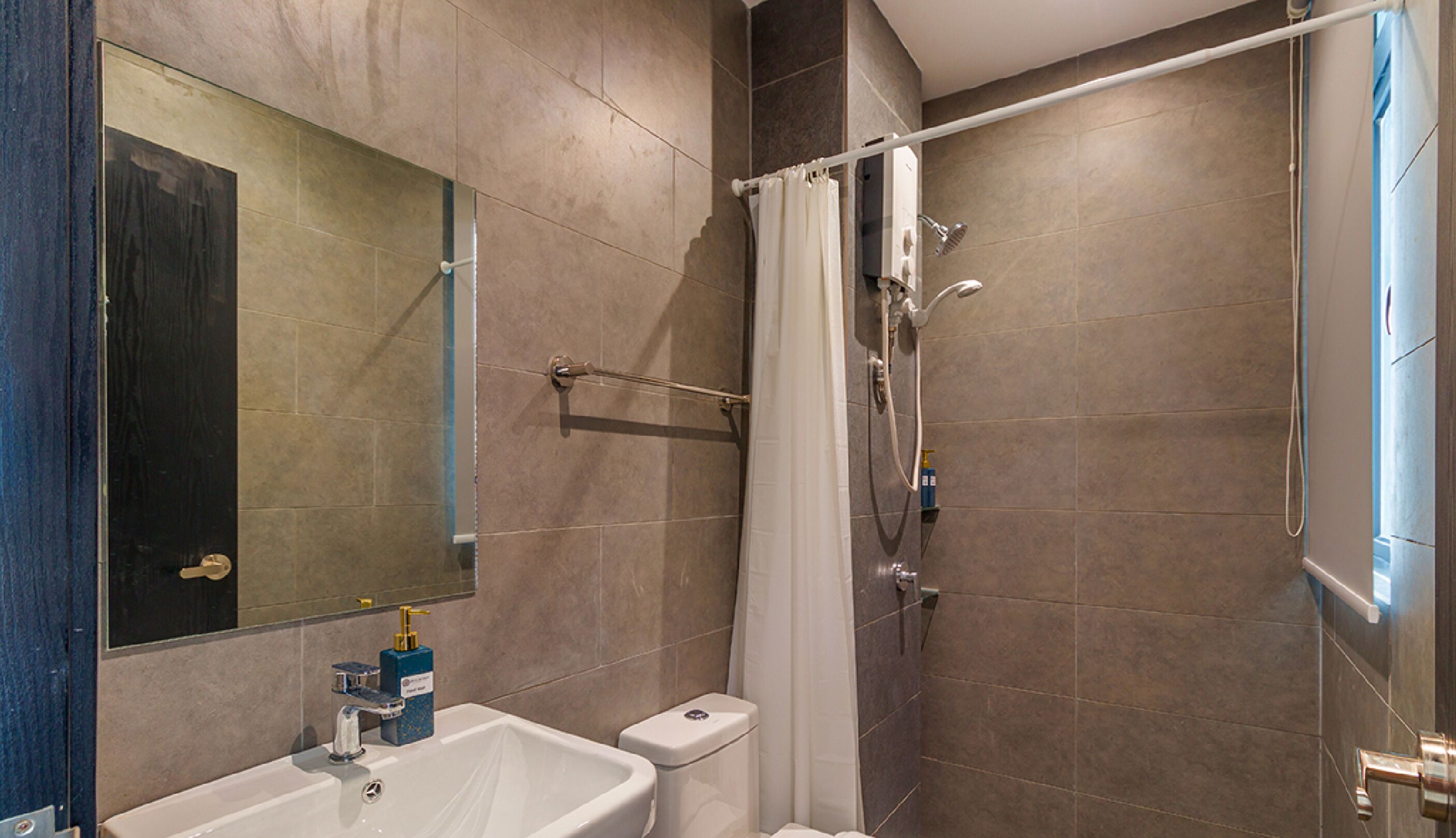 A bathroom with a bathtub, a toilet, a sink, and a mirror.