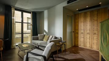 Una sala moderna con un sofá, sillones, una mesa de centro y vistas a través de un ventanal.