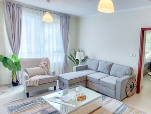 Deluxe Apartment | Living area | 55-inch Smart TV with cable channels - Yogi - City Sophistication 1BR Apt at The Residences 7 (Dubai)