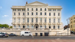 Un grand bâtiment de style classique, doté d’une façade symétrique, de nombreuses fenêtres et d’une entrée centrale.