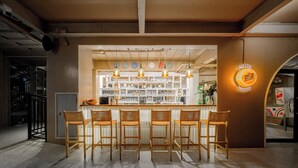 A bar area with wooden chairs, a counter, and a Miller Brewing sign. - Centara Life Lamai Resort Samui (Koh Samui)