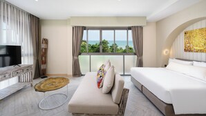 A modern hotel room with a large bed, a TV, and a view of the ocean. - Centara Life Lamai Resort Samui (Koh Samui)