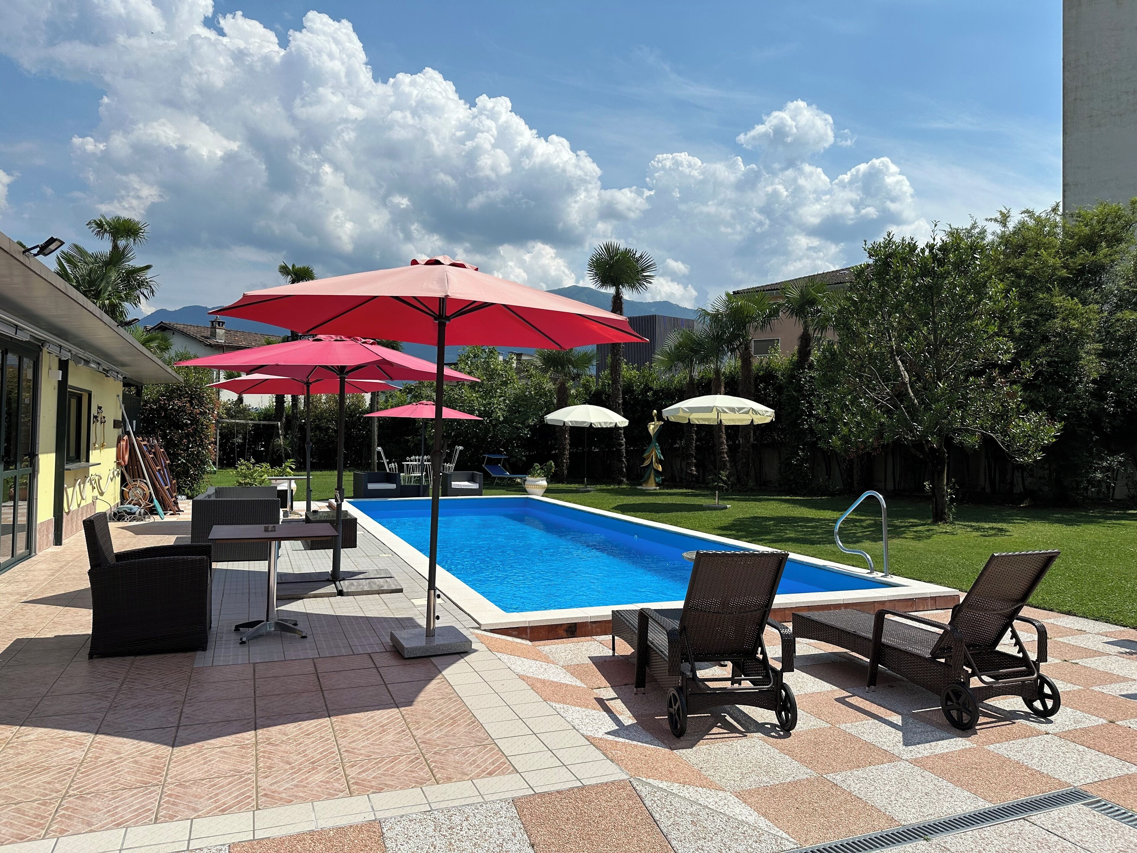 Seasonal outdoor pool, open 10:00 AM to 6:00 PM, pool umbrellas