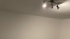 A sectional sofa with multiple cushions, a wooden coffee table, and a ceiling light fixture. - Gemütliche 3 Zimmer Wohnung in Wolfenbüttel Linden (Wolfenbüttel)