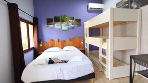 A room with a bed, bunk beds, a window with curtains, and wall art. - Chambre Familiale Périgord (VITRAC)