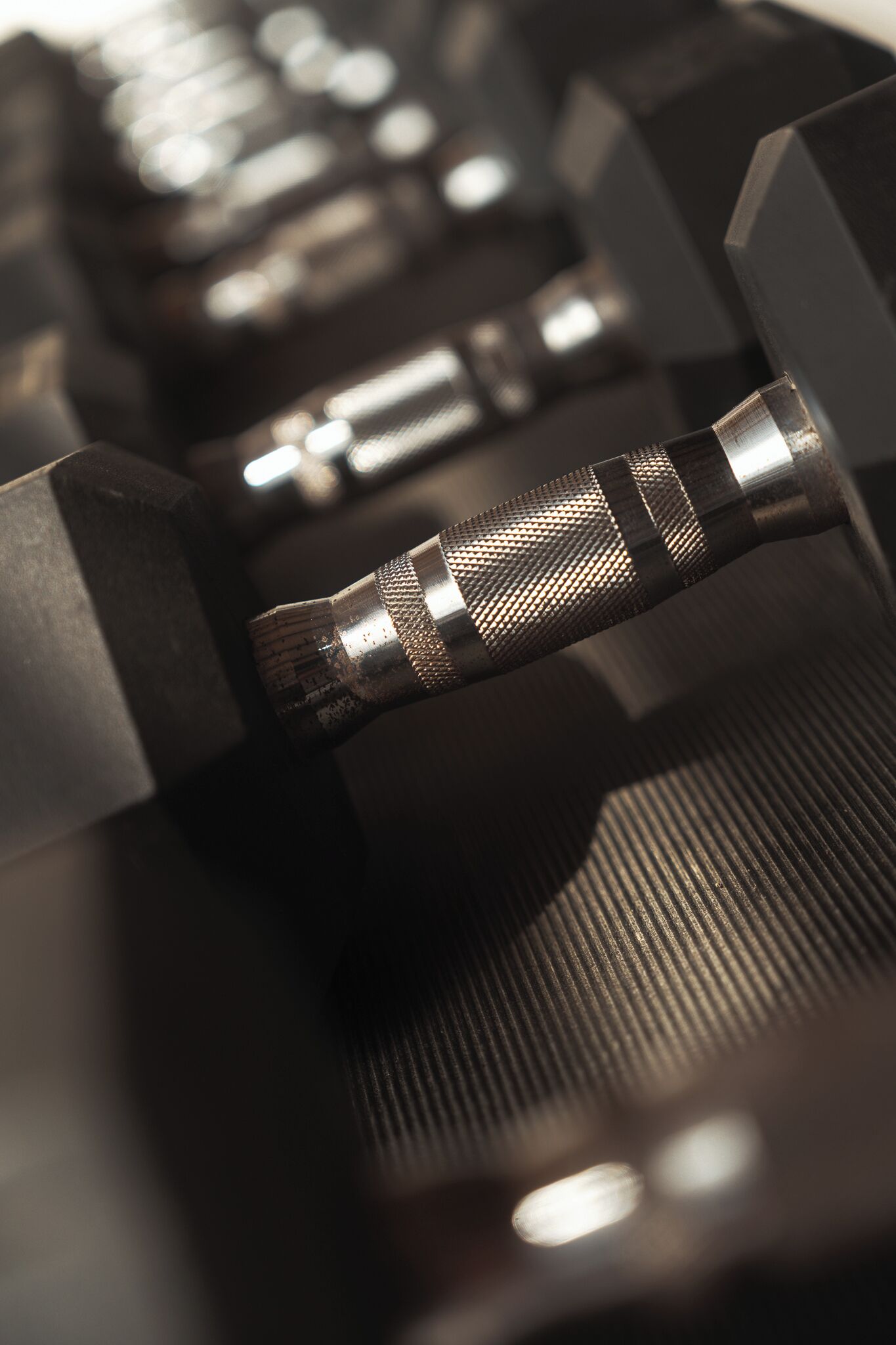 A close-up of a metallic object with a textured surface and a reflective surface.