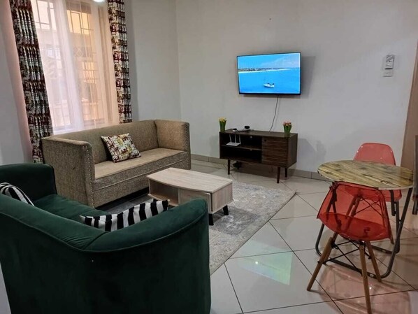Business Apartment | Living area | 24-inch Smart TV with digital channels - Lux Suites La Vida Startup Apartment (Mombasa)