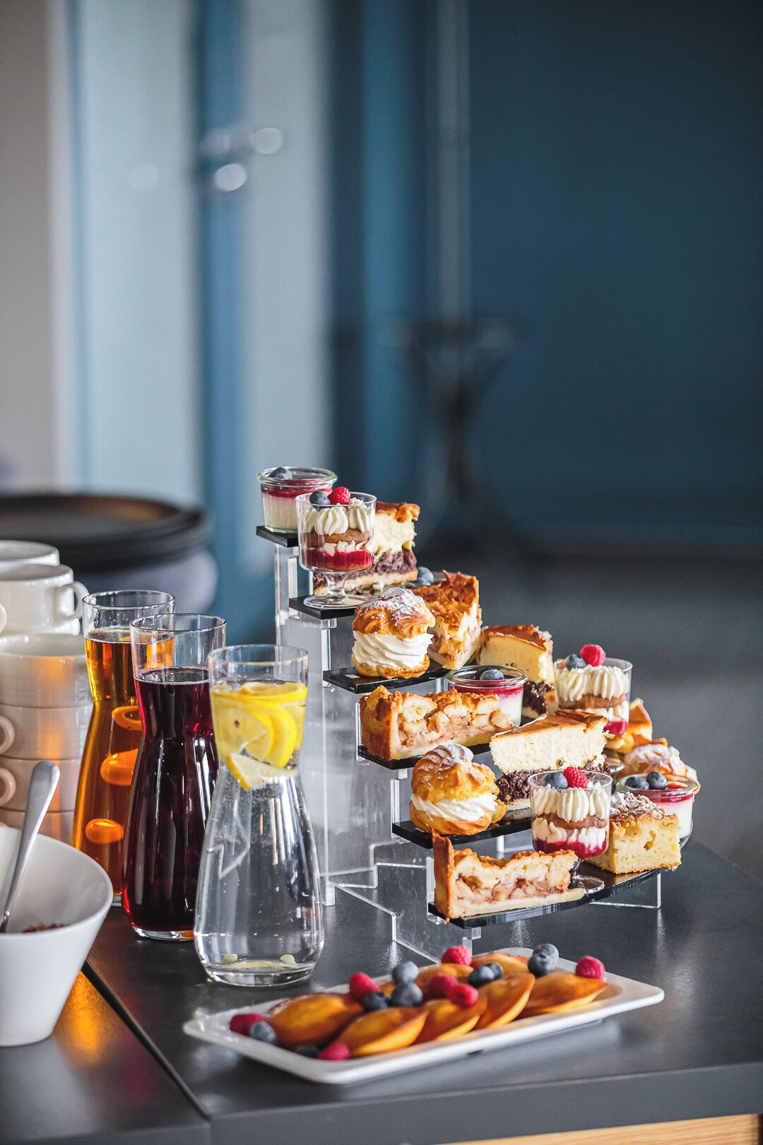 A dessert display with various pastries and beverages.