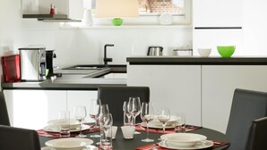 A modern kitchen with a dining area.