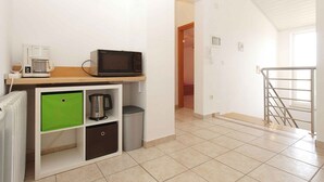 A small kitchenette with a microwave, coffee maker, and storage cabinets. - Holiday apartment with 2 bedrooms and terrace (Banjole)