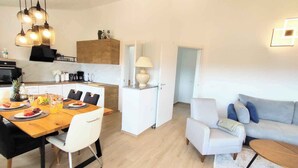 A modern apartment with a dining area, kitchen, and living room. - Holiday apartment with air conditioning with terrace in modern apartment (Pula)