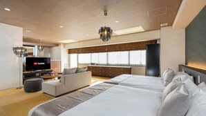 A modern hotel room with a large bed, a sofa, a TV, and a large window. - JAPAVISTA Xenith Premium (Osaka)