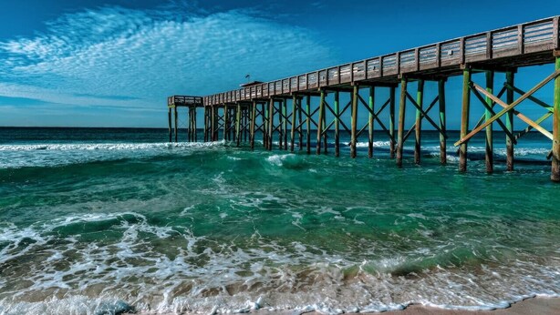 A pier extending into the ocean with clear skies. - Edgewater Golf Villas 1714 | Family-Friendly Community, Beach Access, Lagoon-Style Pool (Panama City Beach)