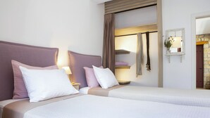 A hotel room with two beds, a wardrobe, a mirror, and a small table with a lamp. - Amapola Villas - Private Villas Phos & Agapi (Lefkada)
