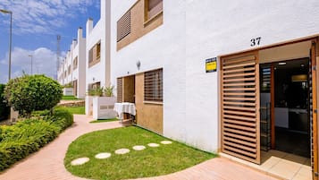 Stylish residence with a garden and wooden deck, featuring a modern design and internet connectivity.