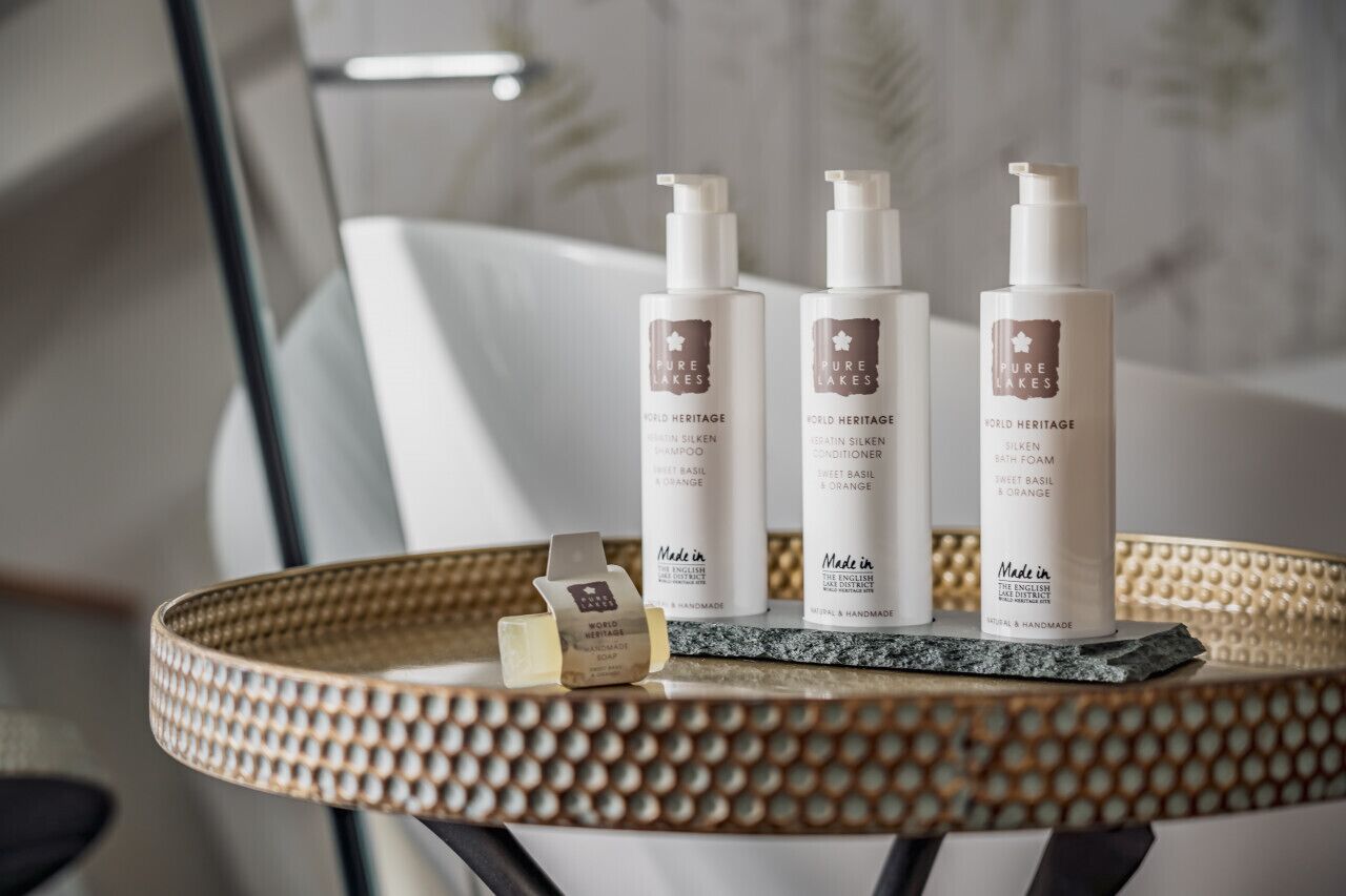 Three bottles of Pure Lakes World Heritage shampoo and conditioner on a tray.