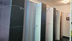 A bathroom with black and white tiles, a shower curtain, and a sign prohibiting washing in the bathroom. - Casa Samor (Bogotá)