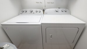 A laundry area with two Whirlpool washers and a dryer. - Oceanfront 2 BR Condo with Shared Pool! Sea Shadow 406  (Surfside Beach)