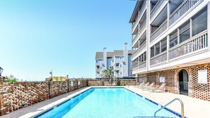 A rectangular swimming pool with a 3 FT depth marker, surrounded by a brick wall and a white balcony with railings. - Oceanfront 2 BR Condo with Shared Pool! Sea Shadow 406  (Surfside Beach)