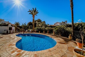 Surrounded by lush greenery and palm trees, this pool area offers a tranquil setting.