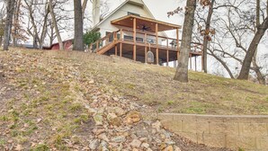 A large, modern house with a spacious deck and a prominent chimney. - Deck + Kayaks: Grand Lake of the Cherokees Home (Afton)