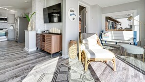 A modern kitchen with white cabinets, a stainless steel refrigerator, and a flat-screen TV. - Waterfront Buckeye Lake Home w/ Deck & Dock! (Buckeye Lake)