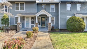 A two-story house with a front porch, a brick pathway leading to the entrance, and a well-maintained lawn. - Lakefront Moneta Home w/ Community Dock! (Moneta)