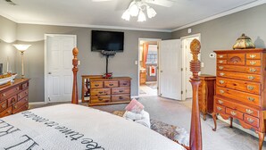 A bedroom with a bed, wooden dresser, and a ceiling fan. - Spacious Trappe Getaway w/ Outdoor Pool & Gazebo! (Trappe)